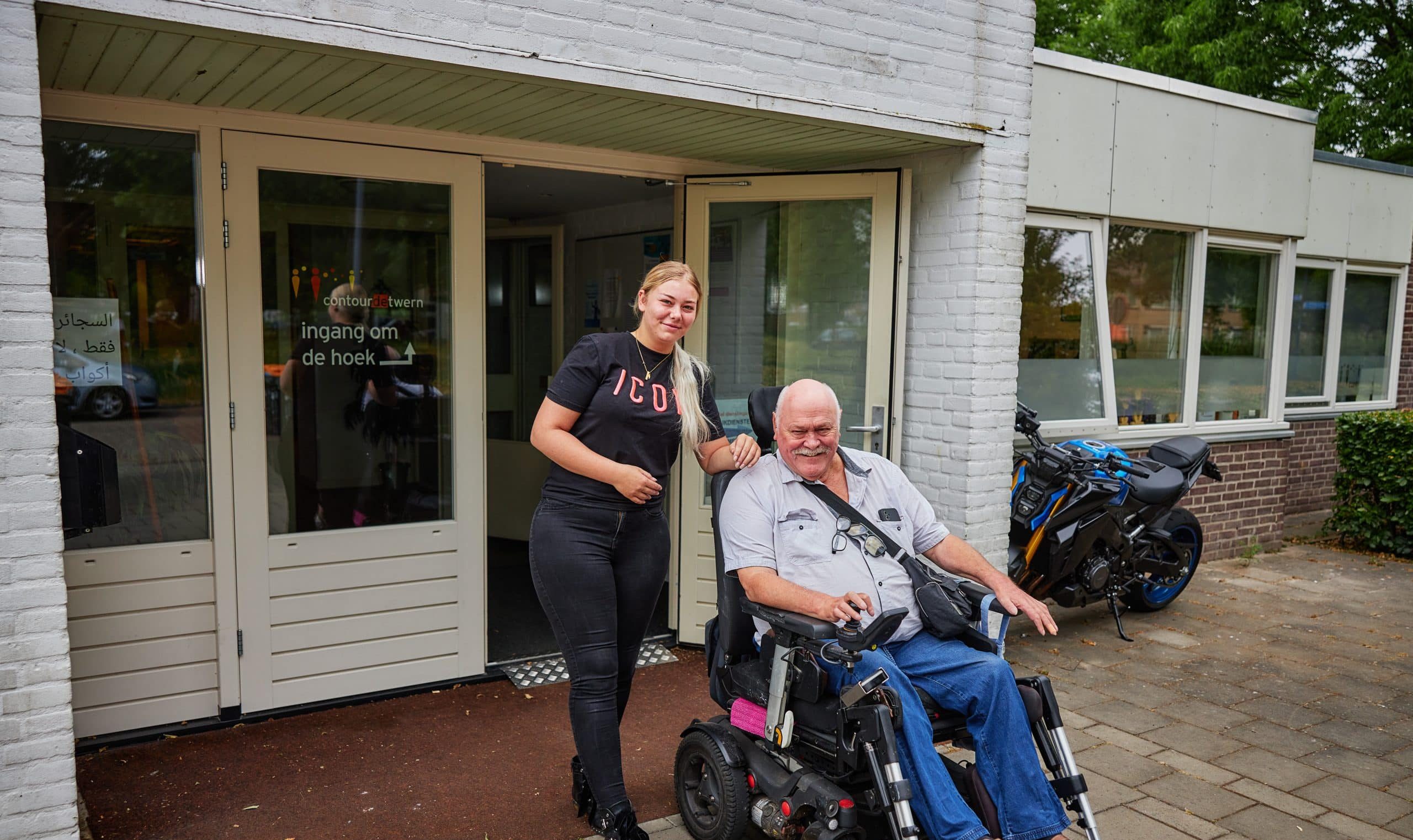 Vrouw vrijwilliger van man in rolstoel